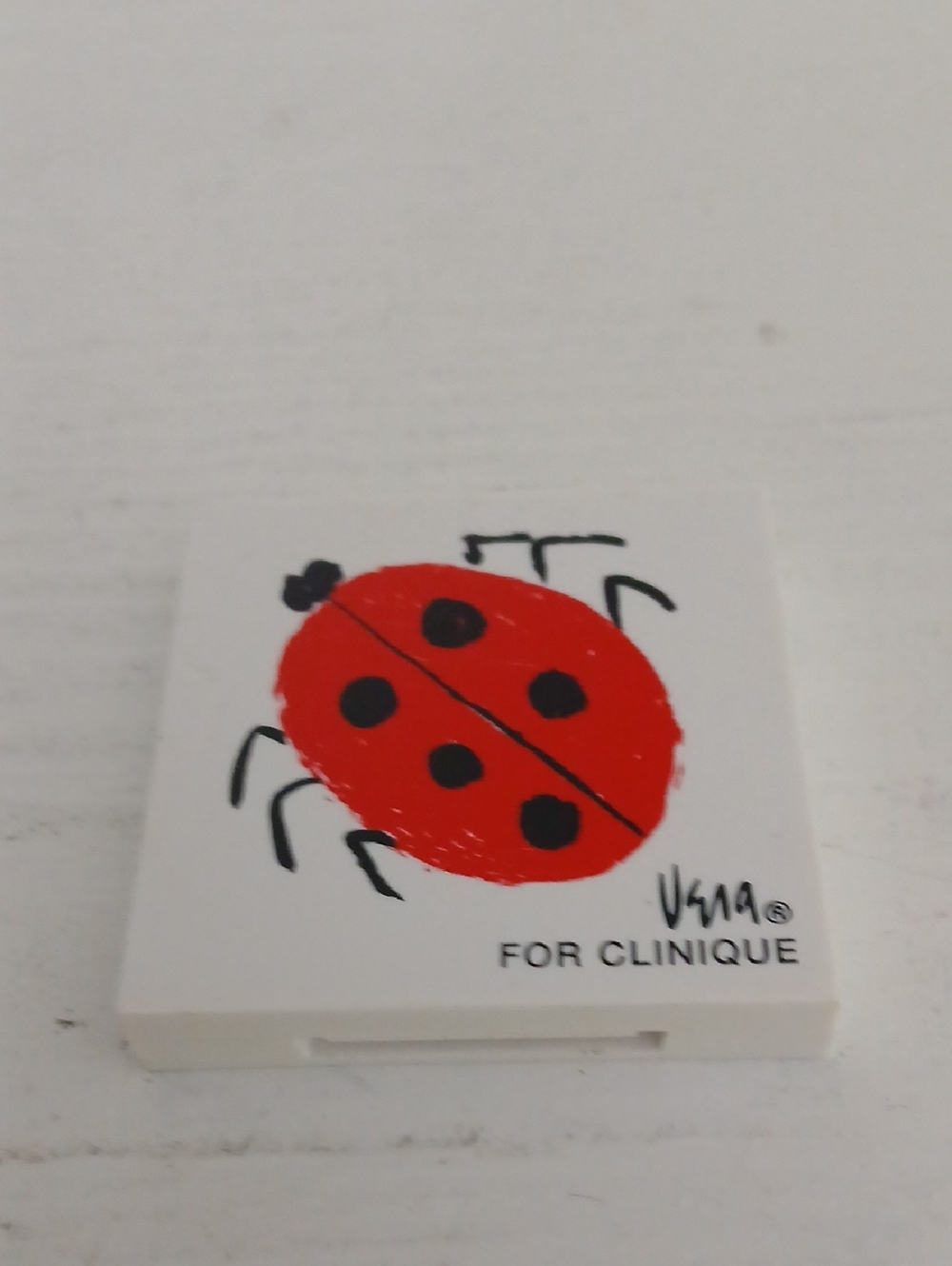 Clinique White Compact with Red Ladybug Motif